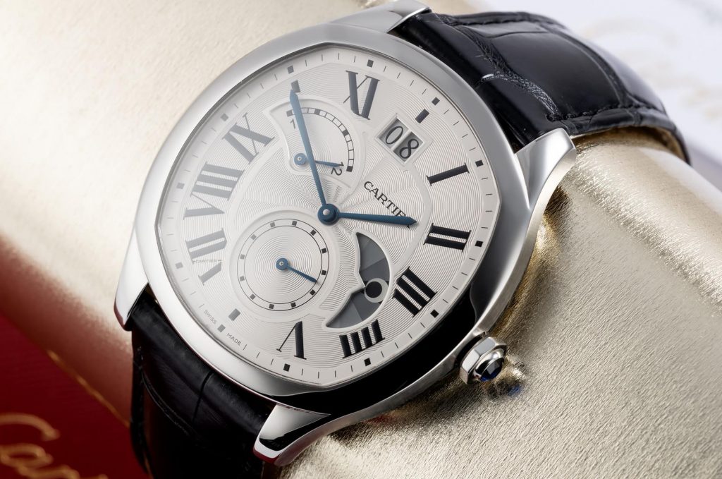 The silvery dial fake watch has a black strap.